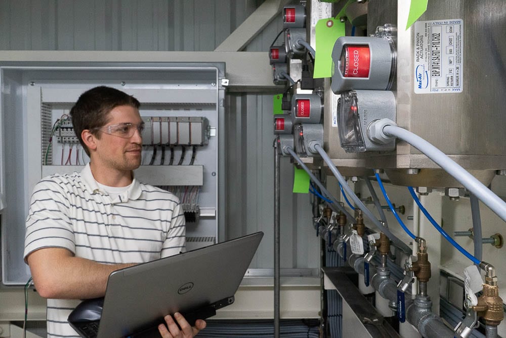 Industrial automation engineer inspects a line system.