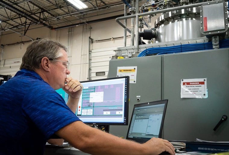 An engineer runs FAT testing on a process skid