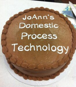 A cake that reads "JoAnn's Domestic Process Technology"